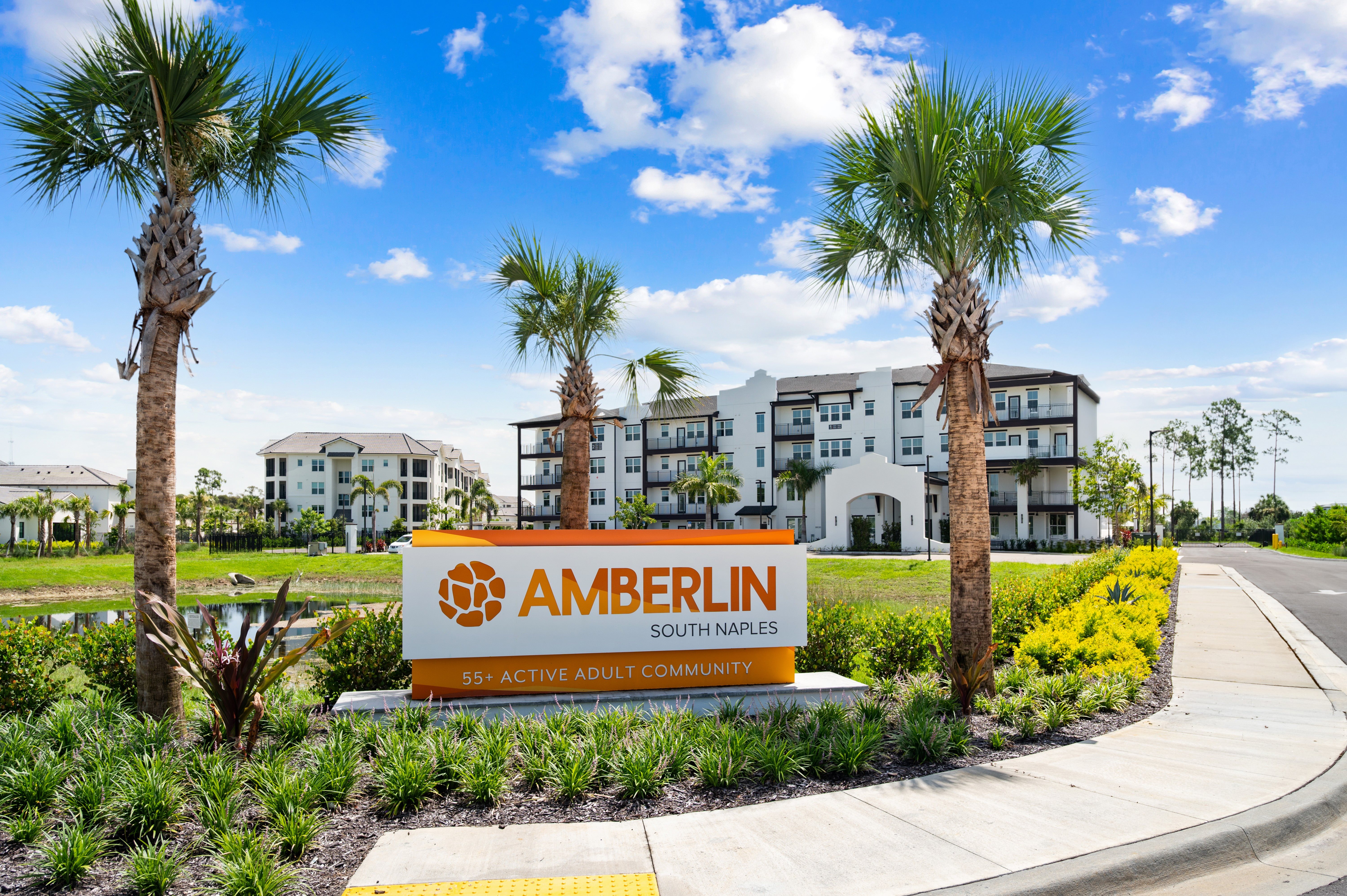 A sign for Amberlin South Naples in front of a building.